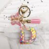 Sleutelhanger LETTER D roze met vlinder en franjes BRL328D