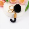 Sleutelhanger LETTER J met pompon zwart en goud BRL342J