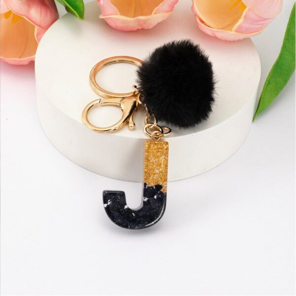 Sleutelhanger LETTER J met pompon zwart en goud BRL342J