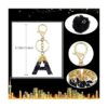 Sleutelhanger LETTER J met pompon zwart en goud BRL342J